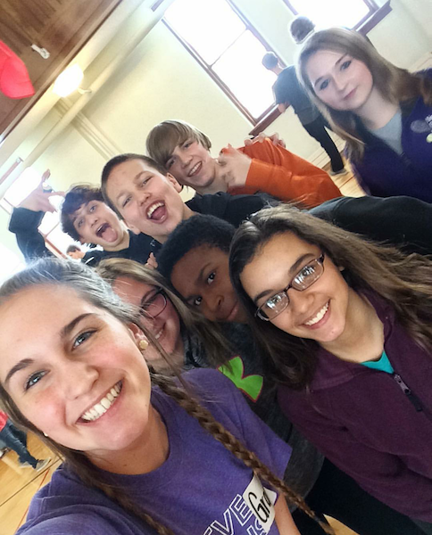 Grace Nelsen snaps a photo of her and her 8th grade small group. 