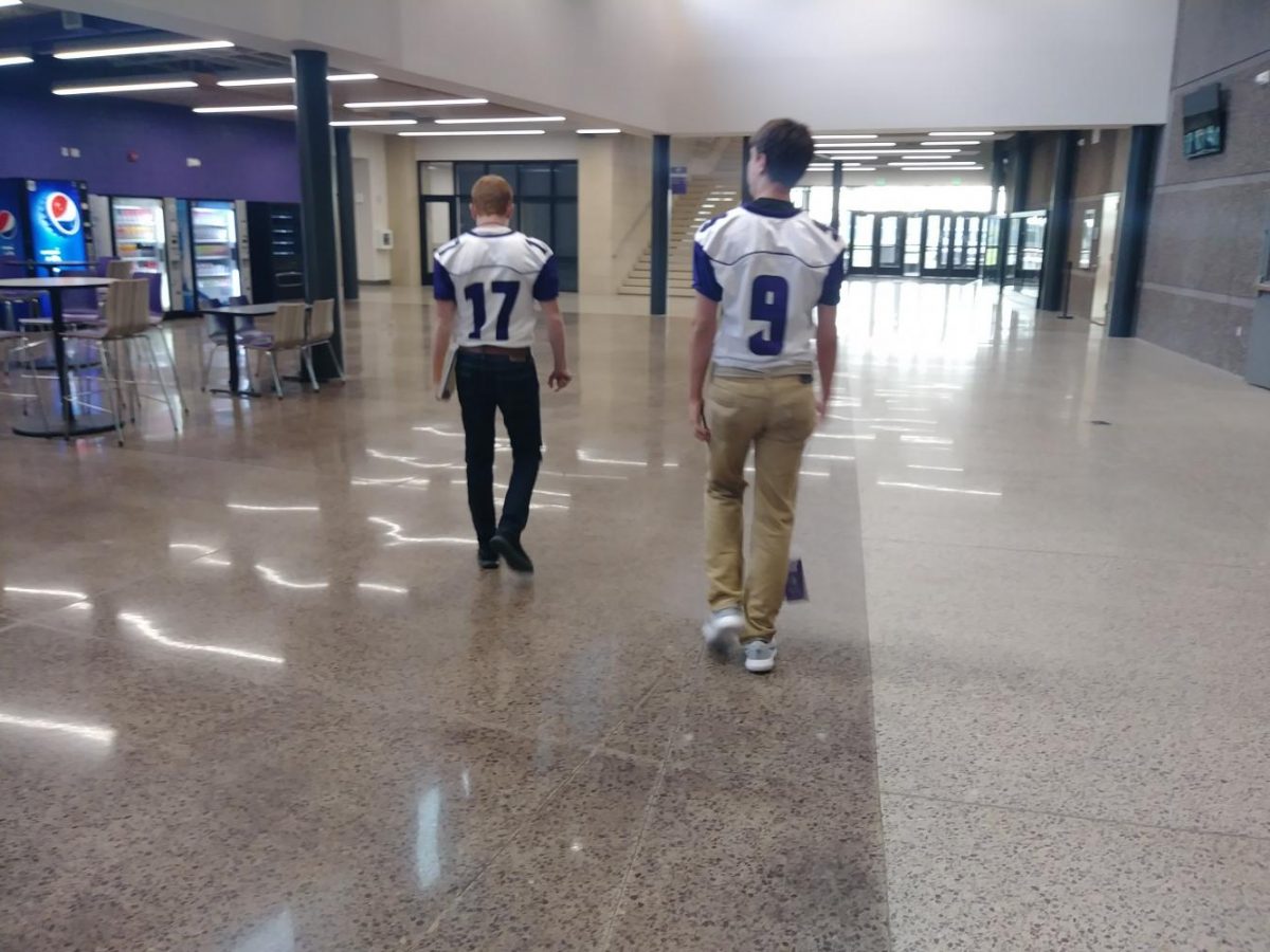 Some football players are ready for the game on Purple Pride day