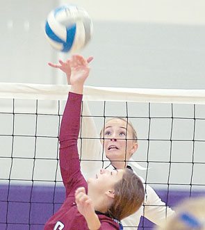 Ashlyn Donner tipping the volleyball over the net. 