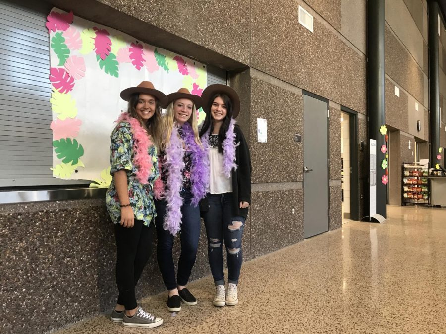 FLORAL FRIDAY Juniors Abbey Fraunholtz, Carli Botton, and Taylor Forstner pose for picture at the photo booth