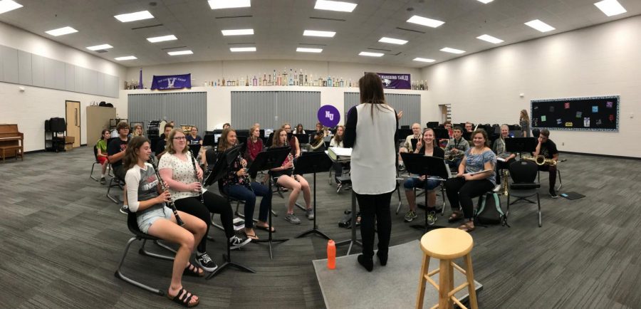 Miss Koehler is talking and directing the High School band. 