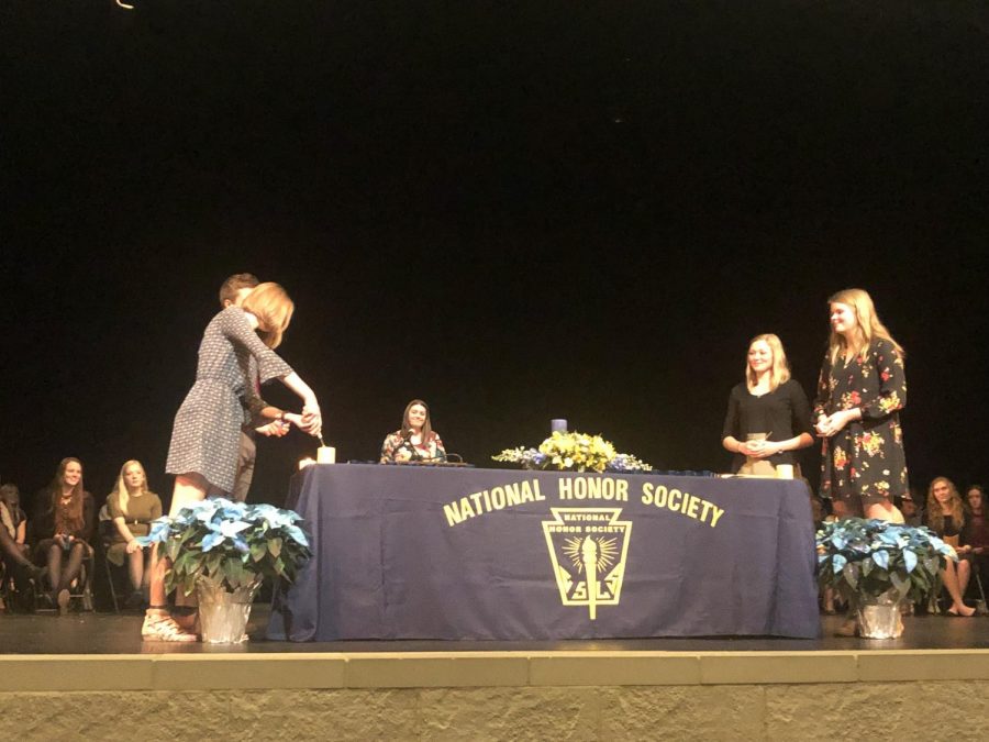 The four officers of NUHS   National Honor Society - Peter Spengler, Emma Maudal, Nori Ness and Hannah Blumhoefer - lighting the four pillar candles.