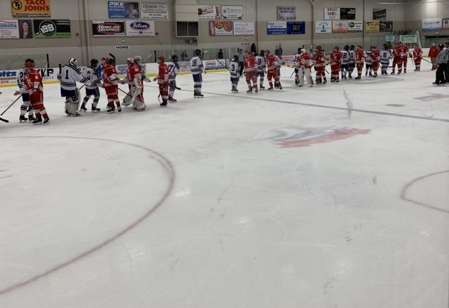 New Ulm hockey boys shaking hands with rival Luverne players after a hard fought 4-1 victory.