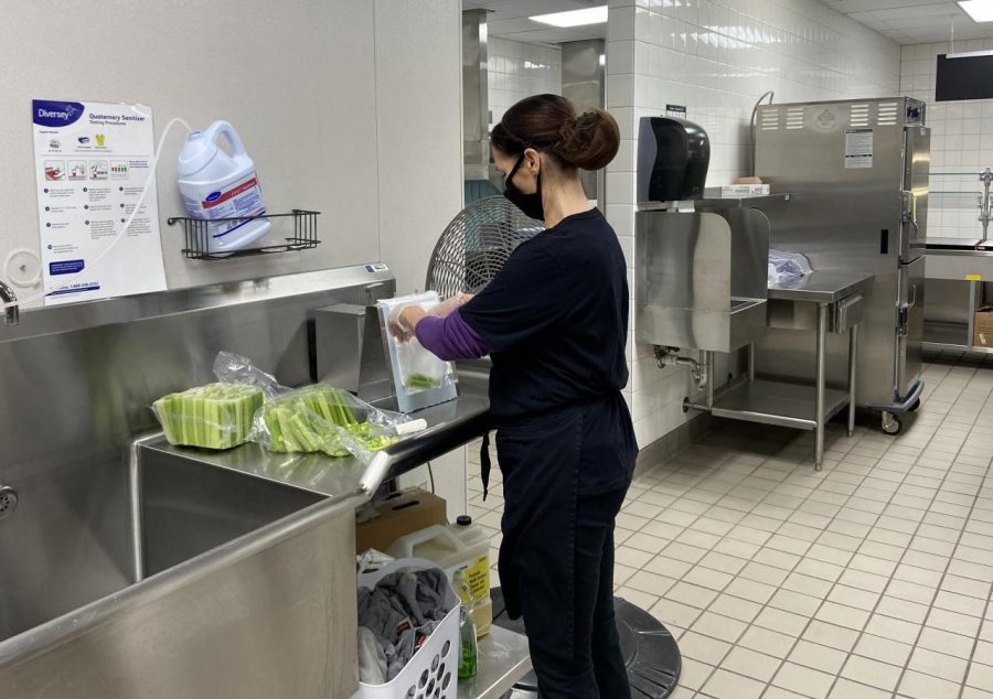 Mitzi Marti - Lunch Staff Member of ISD #88 is captured spending her morning preparing individually wrapped Celery for New Ulm High School Student and Staff lunches due to COVID - 19 Pandemic outbreak. Marti said, Preparing lunches for Students and Staff Faculty and following the COVID - 19 guidelines has impacted us being it now takes us an extra 45 minutes longer than it used to, to prepare school lunches since we need to individually wrap and pre-package all foods. The Pandemic has changed a lot of things from past school years to this school year. 