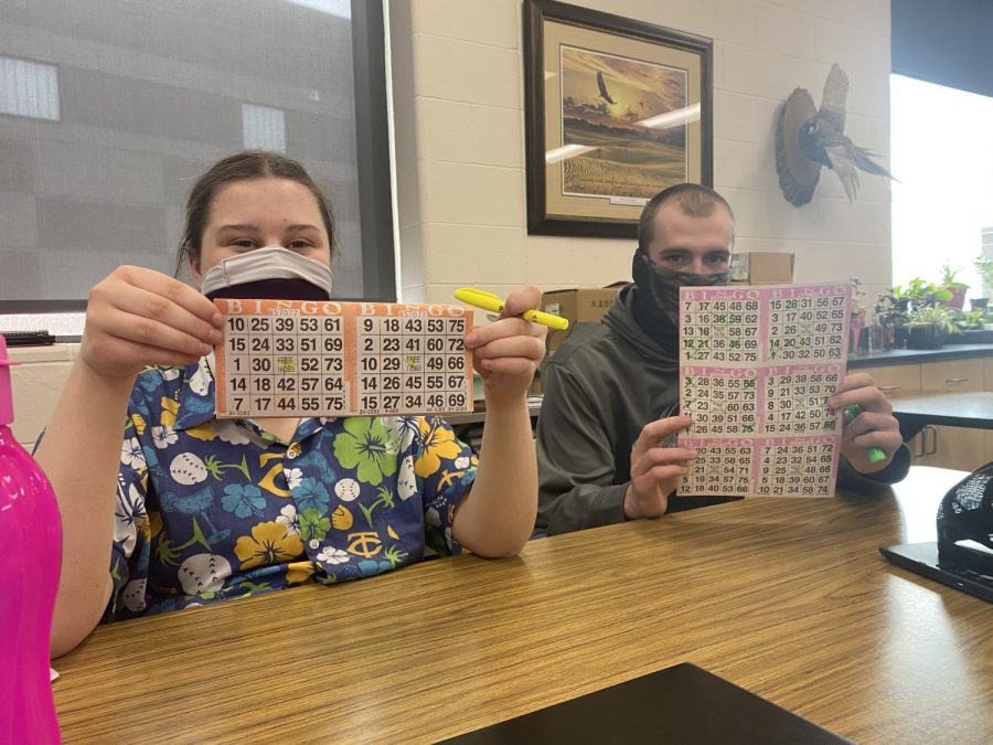 Brynn and Tyler hold up their easter bingo cards!