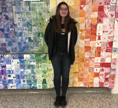 Apprentice student Faith Siegfried poses outside of the elementary art classroom. 