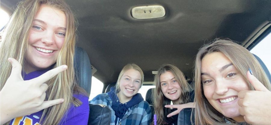 Juniors Calyn Glaser (left), Laura Bertrang, Addy Rustin, and Kate Frauenholtz hanging out in the car on a cold day.
