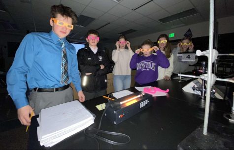 Juniors Collin Horning, Nick Zins, and other classmates in Ms. Filzens lab doing an experiment on light and color.