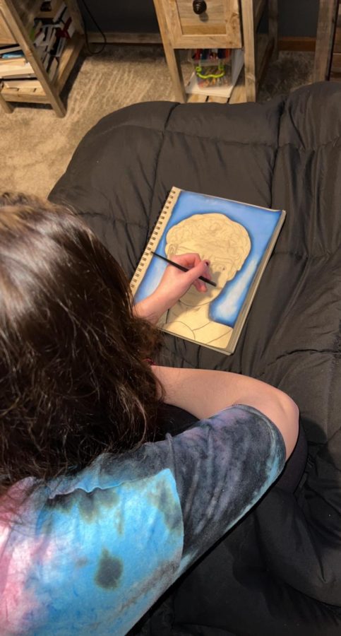 Faith Hennessey is coloring her drawing of David of Michelangelo
