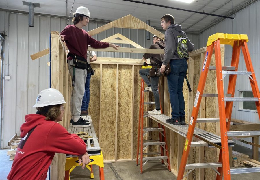 On Tuesday, Feb. 3, NUHS students at the CTE center began learning how to build a shed to further their skills and education in the trades department and learn the basics of building houses. While building this shed, the carpentry students learn many life skills, technical skills, and how to work together to achieve the best possible results, Mr. Briggs said. Luke Steffensmeier and Ben Hohensee work together to construct and set the trusses on top of the shed to create the roof. Setting up the trusses is just one of many steps to complete the building. 