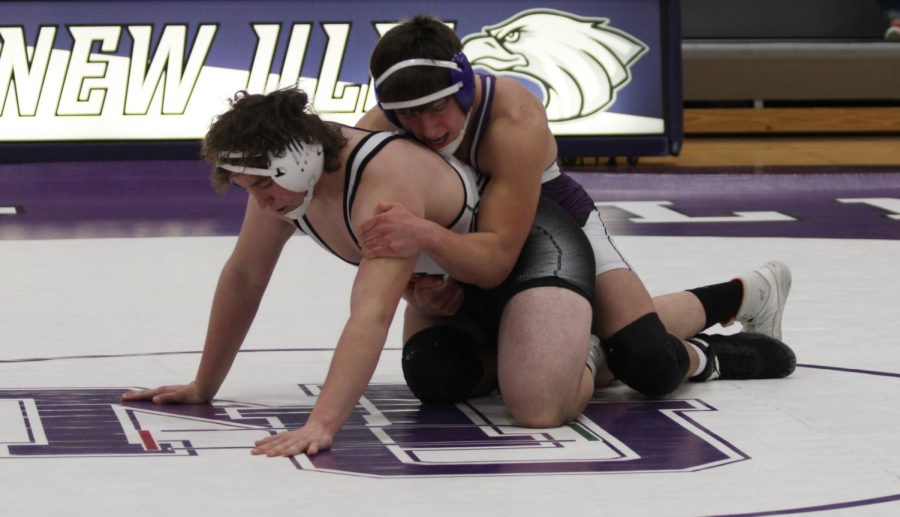 Dylen Carreon attempts to take down his Marshall opponent at a home meet earlier this season.