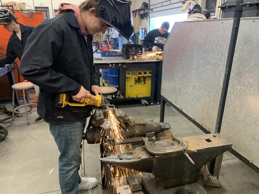 A  student prepares his metal for welding