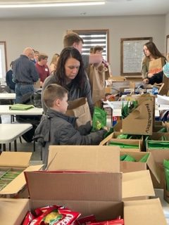 A group of 4-H members and parents helping assemble gift bags for Meals on Wheels. 