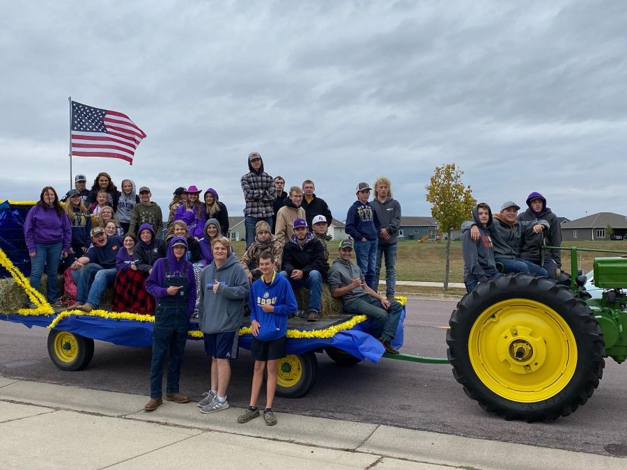 FFA members await the start of the homecoming parade on Friday, September 23rd. The float was pulled by a John Deere model A tractor provided by FFA Vice President, Jared Beranek and driven by FFA officer Andrew Hellendrung.