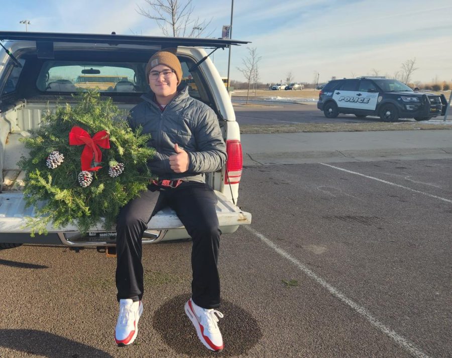 Joey sells custom Christmas wreaths for the Boy Scouts in the NUHS parking lot. 