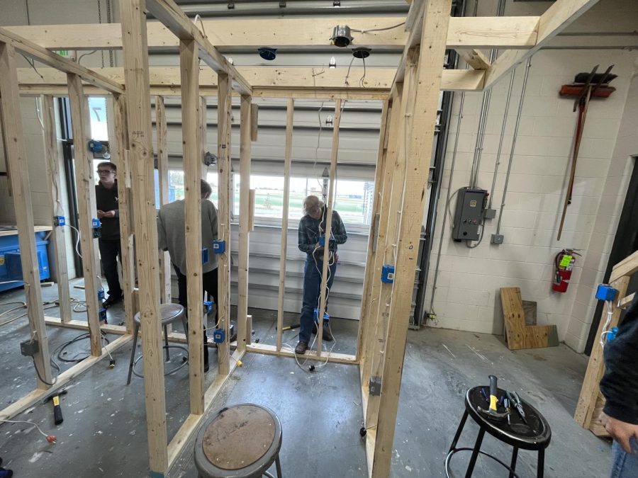 Residential maintenance students Adding electrical to basement frame.