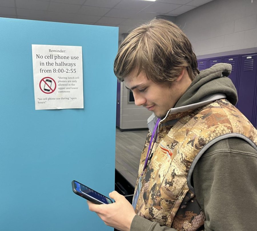 Broddy Enter checks his Snapchat in the school hallways