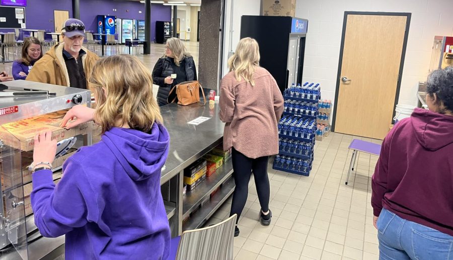 Junior Amber Lee and varsity volleyball coach Sarah Swanson-Cullen handle the hustle and bustle of the concession stand.