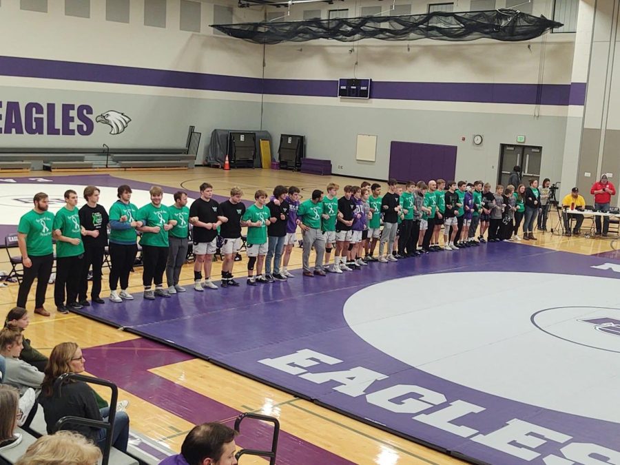 The Eagles wrestling team lined up after the national anthem during a home meet to show that mental health matters.