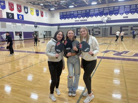 Seniors Addy Fairbairn, Emerson Wenninger, and Bryanna Aschenbrenner posing for a picture during pickle ball.
