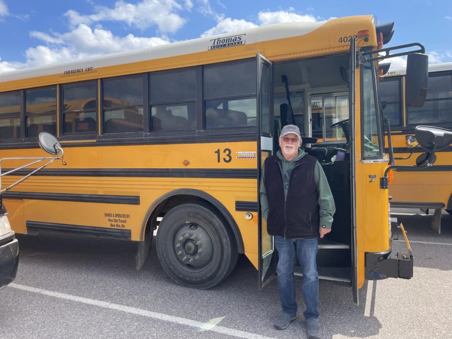 Dave Nelson stands next to his bus while waiting for kids to load at the middle school.
