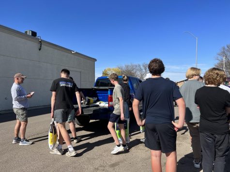 Student athletes from golf, boys tennis, and track and field help out loading softner salt into customers vehicles. The Booster Club raised $9,500 to support New Ulm athletic programs. 