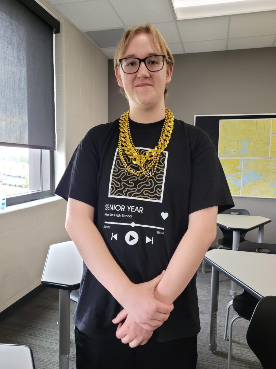 Lincoln Hoffmann, posing with solid gold chains and the Seniors Spotify t-shirt during homecoming week for battle of the classes .