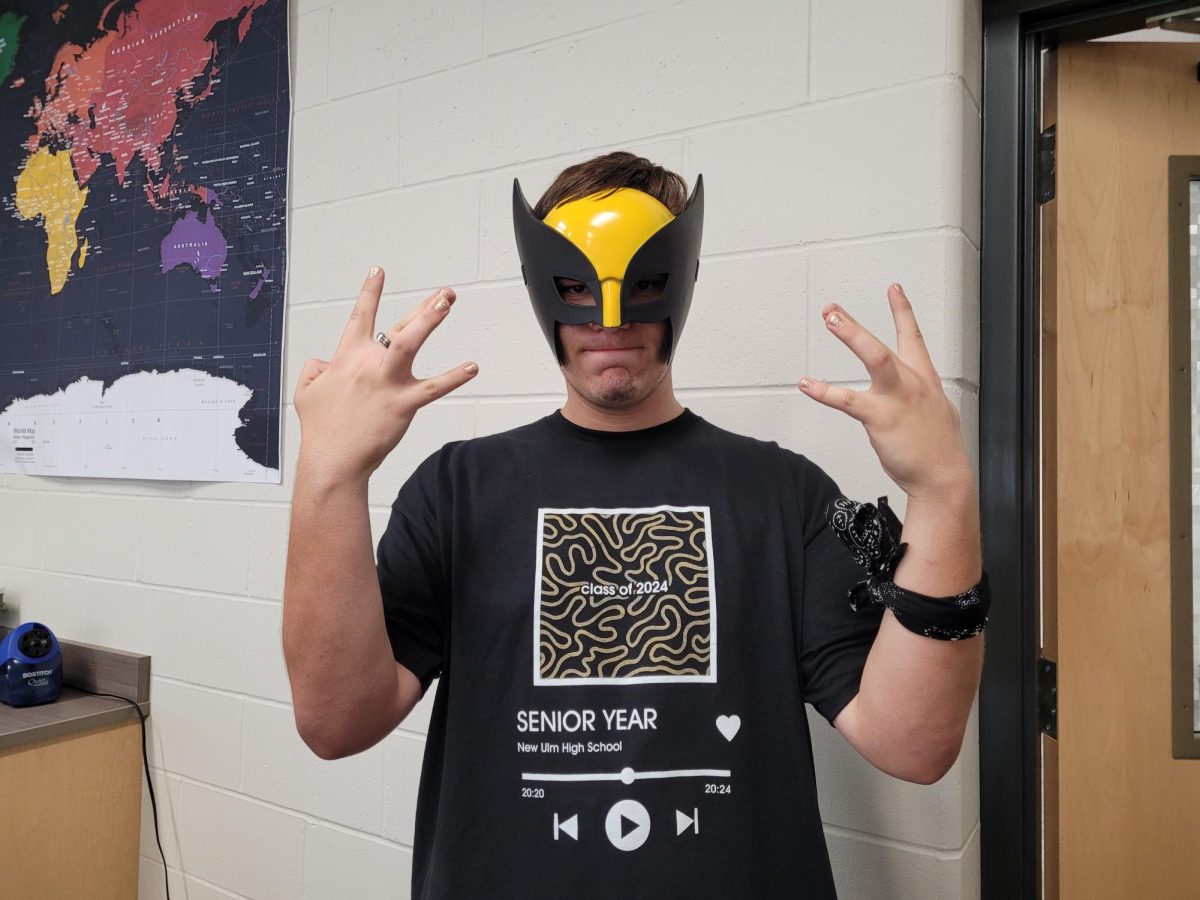 Senior John Haler repping the gold and black mask with the Spotify Seniors t-shirt for the battle of the classes during homecoming week at NUHS .