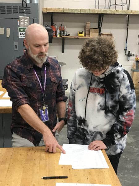 Mr. Gusso helping a student along on a safety test retake.