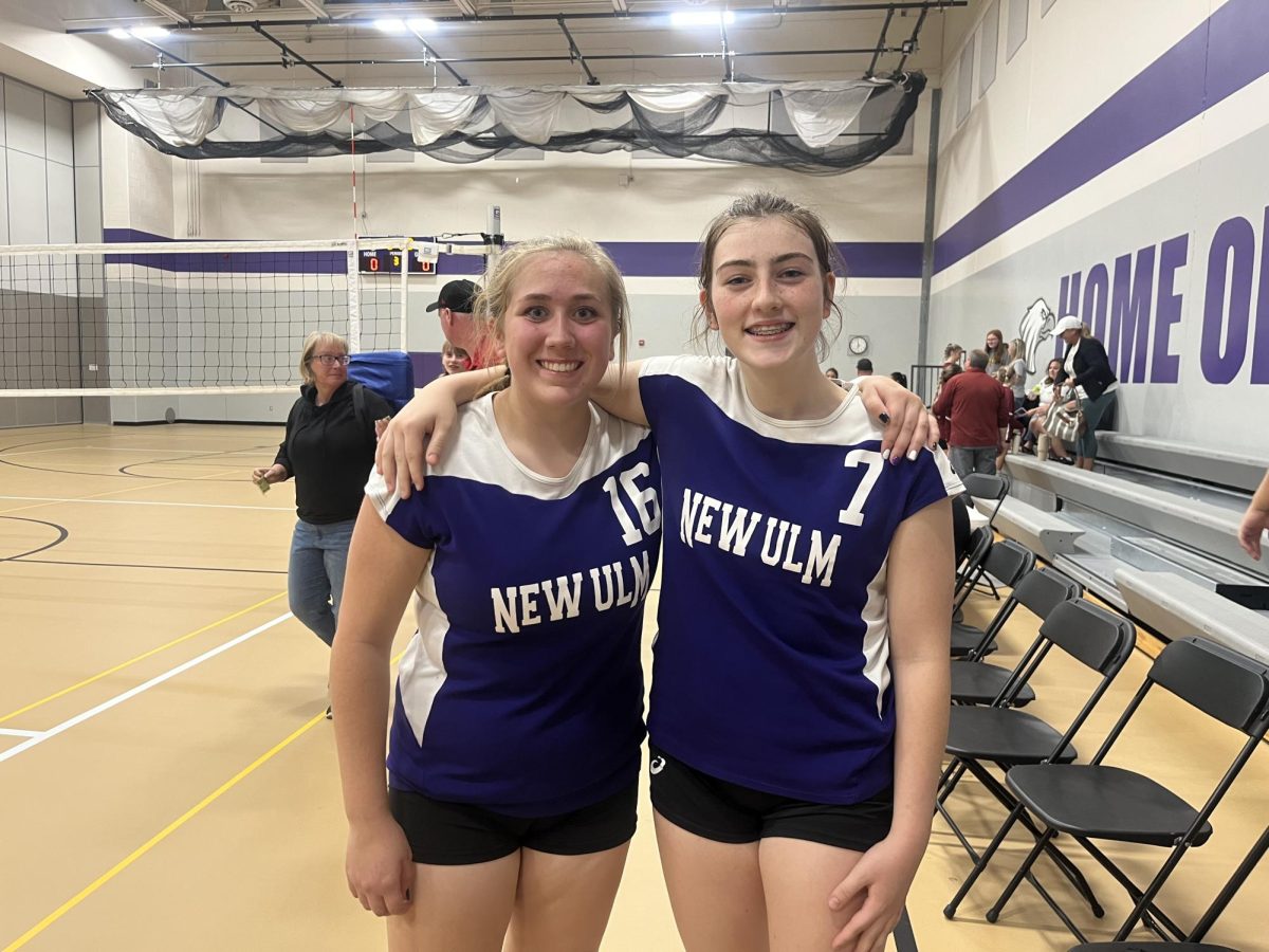 New Ulm C team volleyball players Sadie Revering (16) and Frankie Varva (7) celebrating a win against the Fairmont Cardinals, played here at the New Ulm High School gym!