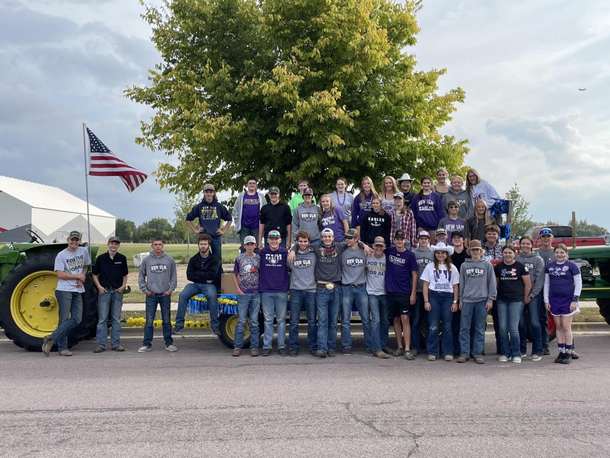The New Ulm FFA gathered together on Friday, Sept. 22 for a photo before the homecoming parade. The students all helped to decorate hay racks provided by FFA Sentinel and Officer at Large, Kolbe and Logan Platz. The hay racks are then pulled through the parade by two tractors donated by FFA Sentinel Kolbe Platz and FFA member Ben Alfred. My favorite part of the parade is throwing candy at little kids and seeing them smile, Kaden Wilson said. (Photo by Jeffrey Nelson)