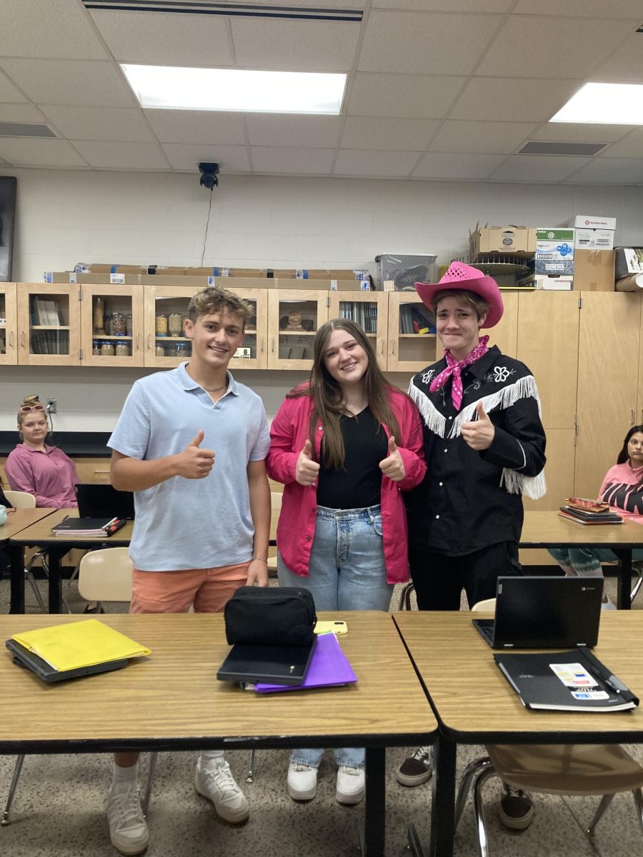 Bryer Hoffman(right) and Nick Vigil(left) dress up as Ken while Lilly McGuire(middle) rocks pink to dress up as Barbie. 
