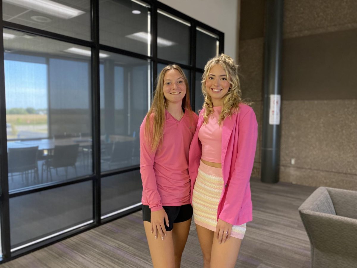 Seniors Ella Ahrens (left) and Alex Groebner (right) pause for a quick picture Wednesday afternoon. My favorite part about homecoming week is definitely all the school spirit and the Friday football game because it brings everyone together, Groebner said. Every day during homecoming week, students dress up according to a designated theme. Wednesday was Barbie day.