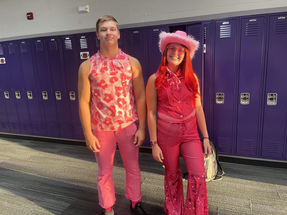 Seniors Cohen Carpenter (left) and Lexi Schneider (right) participate in Ken and Barbie dress-up day during Homecoming week.