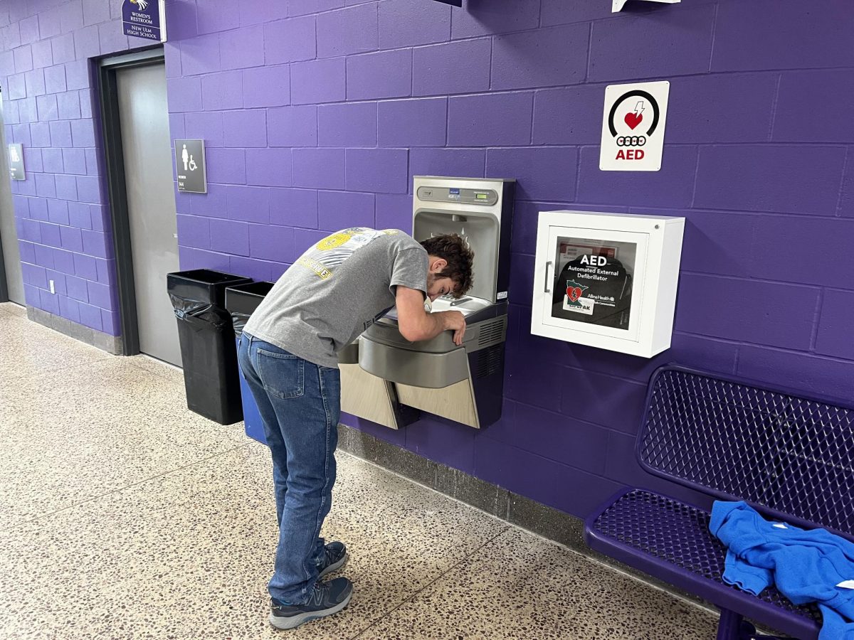 Senior Mark Beranek drinking from the fountain in the gym wing Tuesday morning.