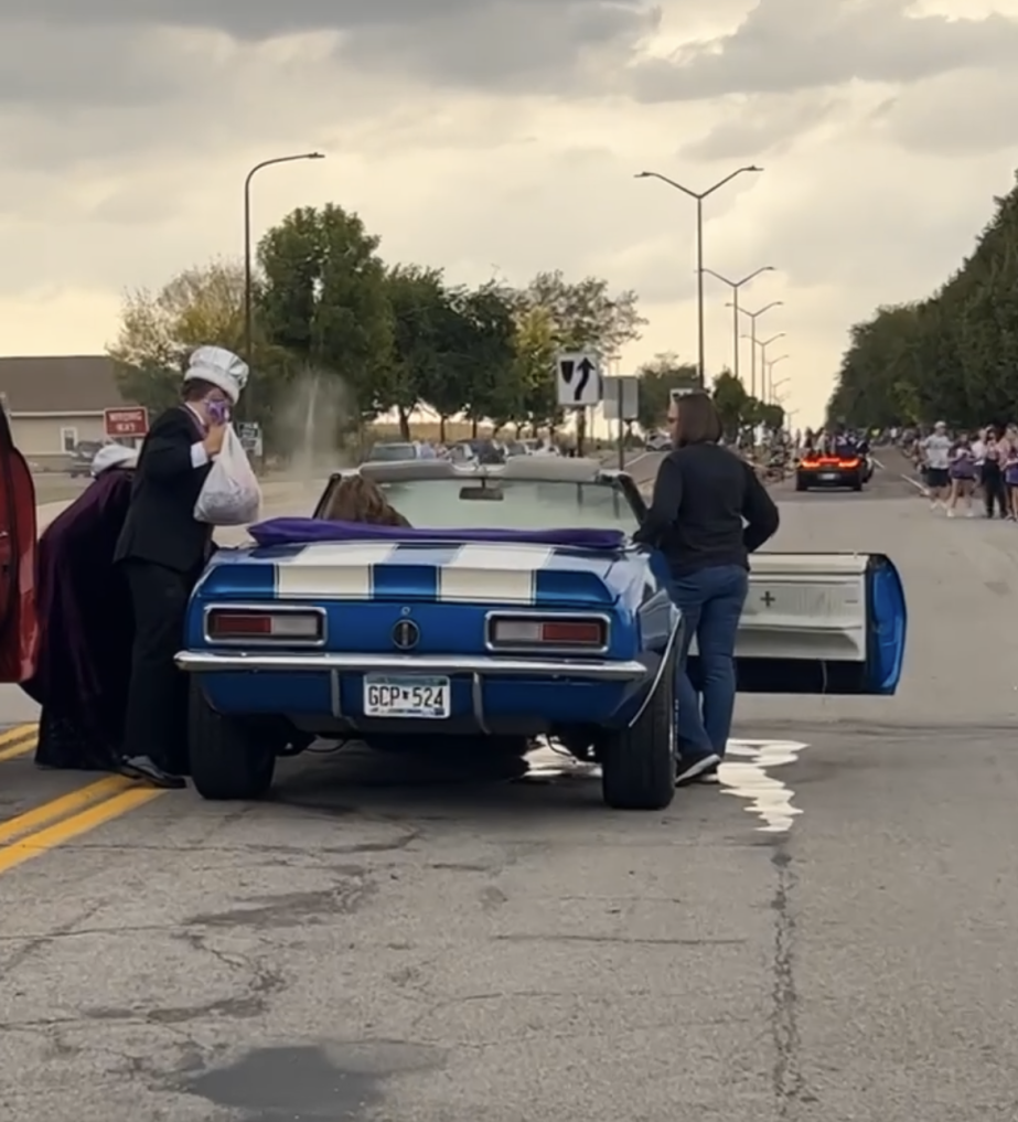 Homecoming King (Bryer Hoffmann) and Homecoming Queen (Alex Groebner) experience car troubles during the Homecoming Parade