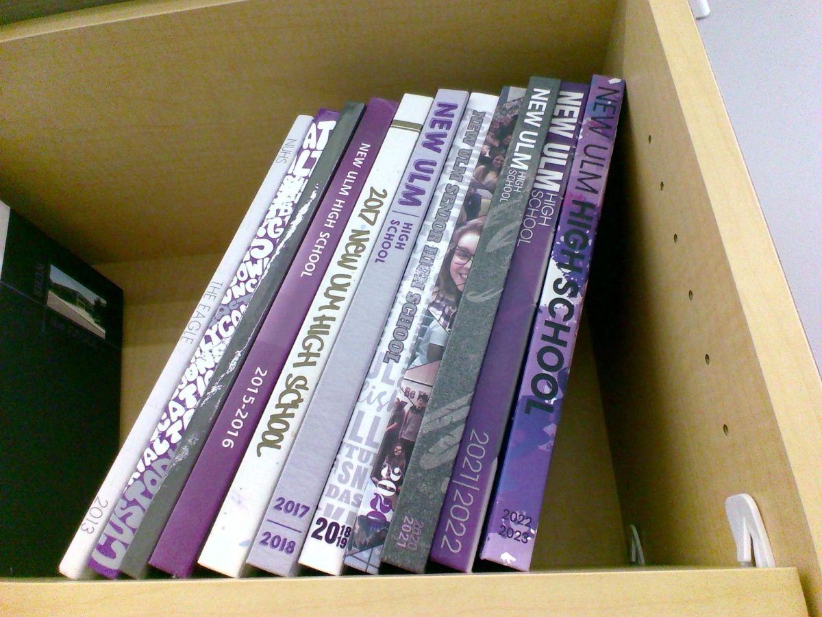 A shelf containing NUHS Yearbooks year 2013-2023.