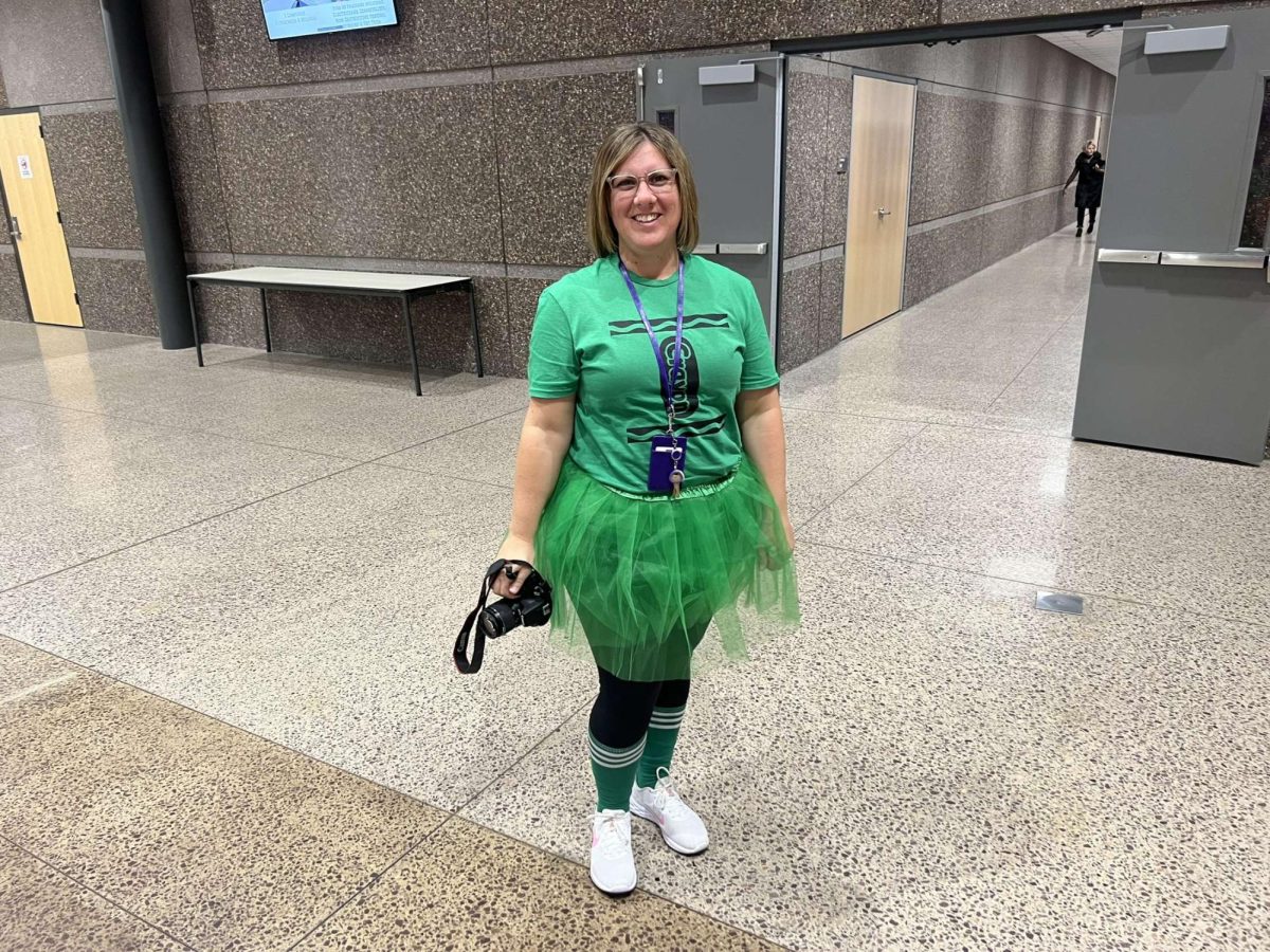 Head school secretary Erin Jensen is dressed up as a green crayola crayon for Halloween 