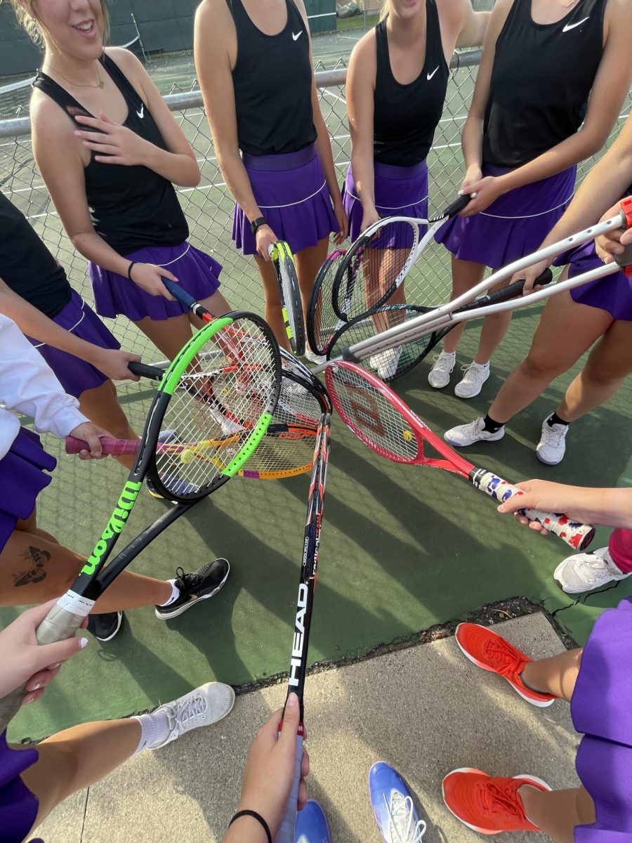 The New Ulm girls tennis team huddles together one last time this year before their match in Prior Lake.