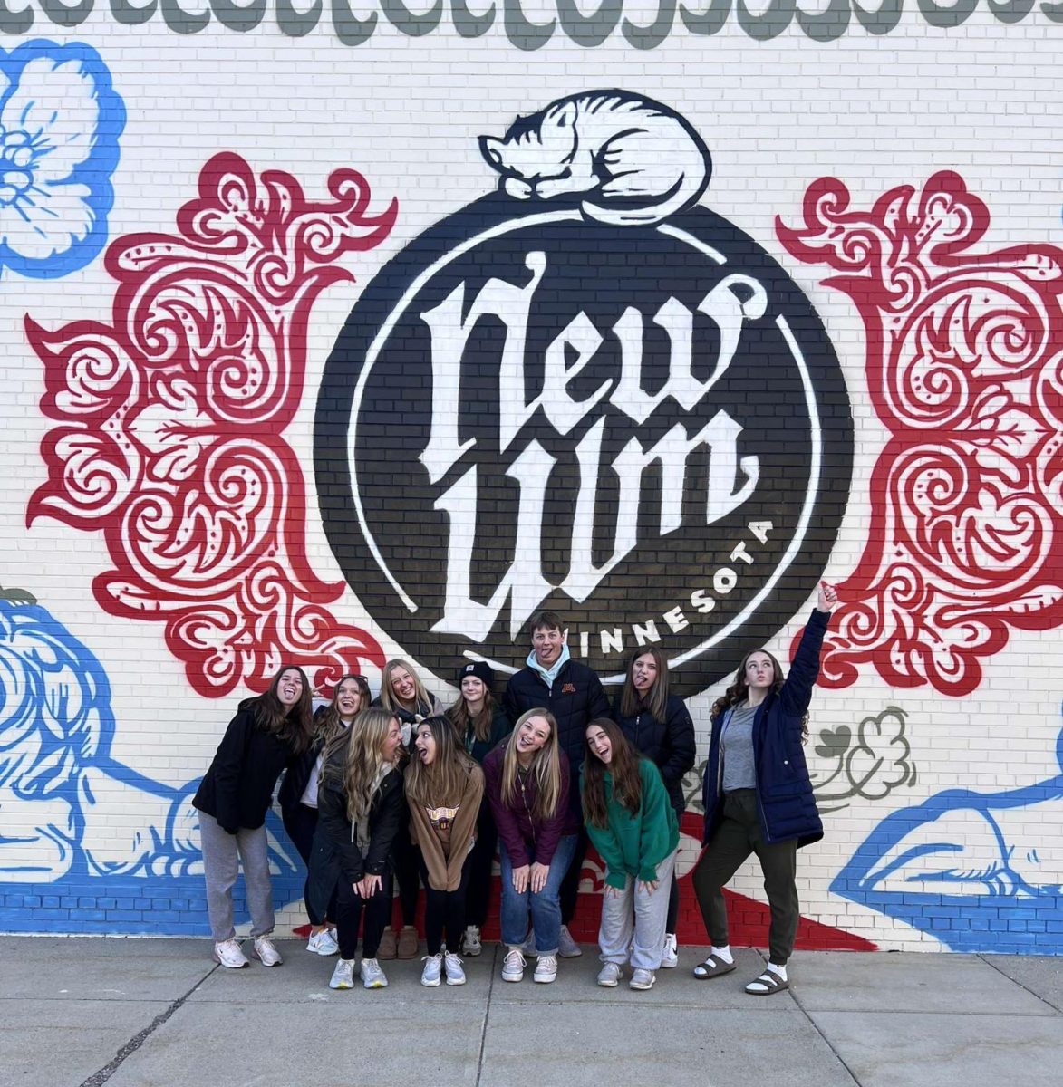Net Work New Ulm Youth students pose in front of a hand painted New Ulm mural when on their historical tour of their town. 