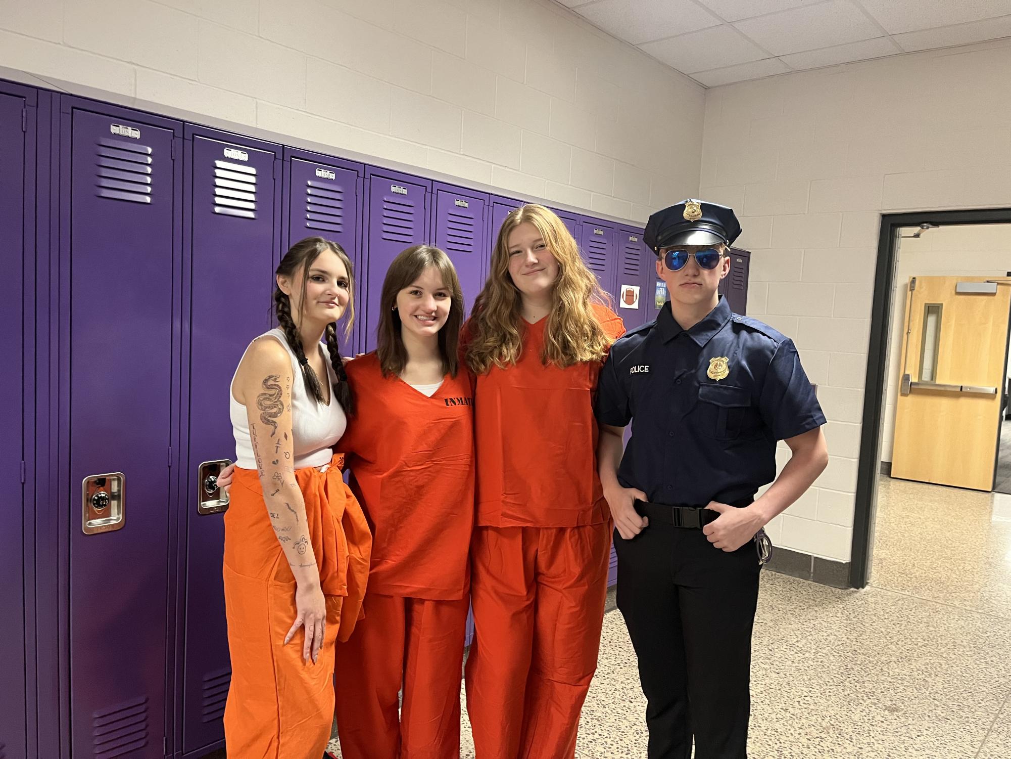 From left, juniors Katelyn Schumacher, Josie Stade, Amanda Vogel, and Brooks Miner pose in their jailhouse attire.