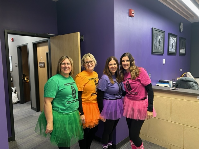 NUHS office ladies dress up as crayons for Halloween.