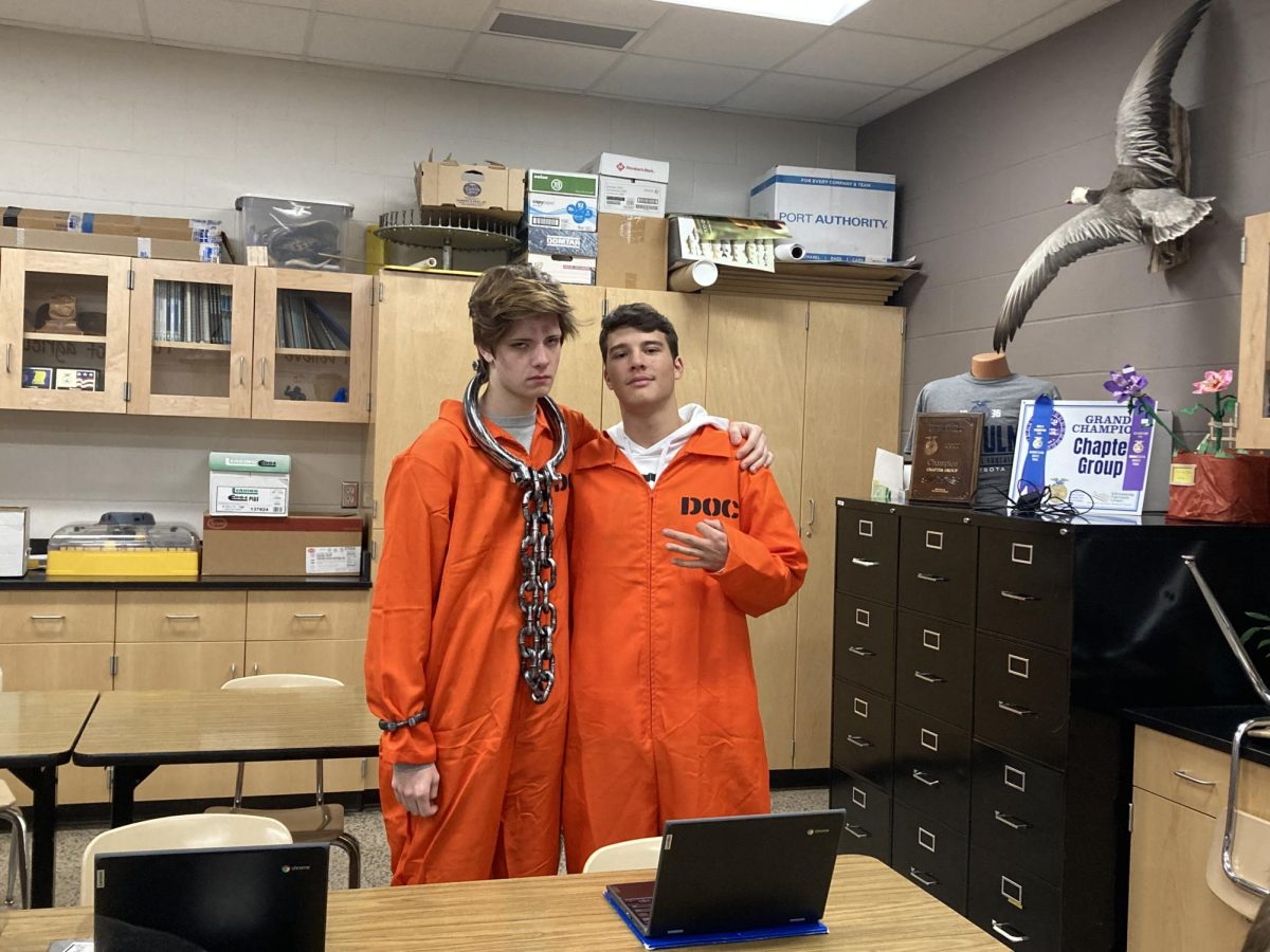 Seniors Nick Vigil (left) and Kyle Helget dress up as prisoners for Halloween at NUHS