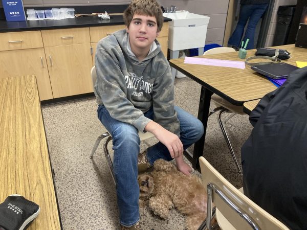 Kamden Melzer hanging out with Rudy(dog) during class work time 
