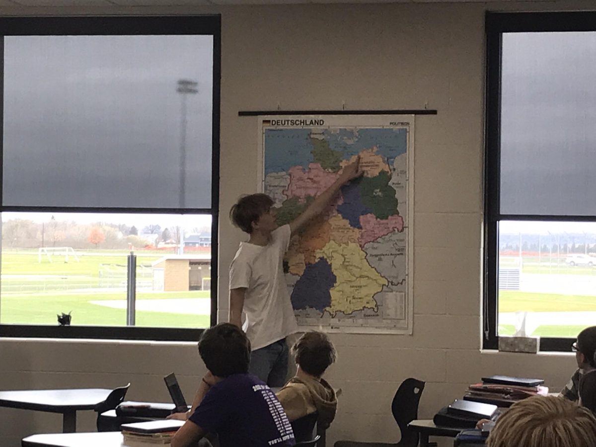 Foreign exchange student Jakob Geiss explaining his home in Germany to people taking German 1