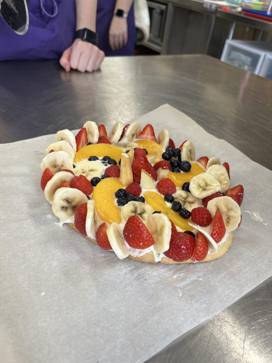 Students in basic foods made intricately designed fruit pizzas. 