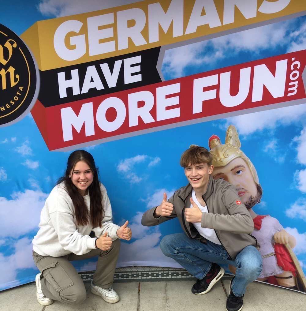 Jule (left) Jakob (right) are posing infront of a picture in New Ulm 