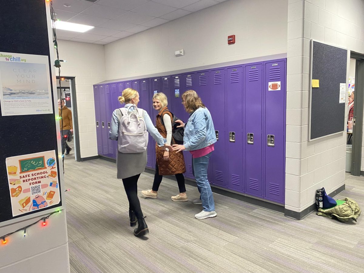 Let the day begin: paraprofessionals Bobbie Altmann, Alisa Anderson and Candace Wilfahrt (left to right) are off to their 1st hour classroom.