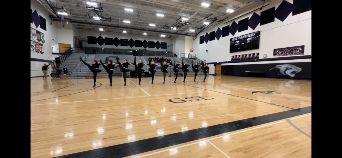 The NUHS dance team kicks to new heights during a competition at Glencoe-Silver Lake High School.