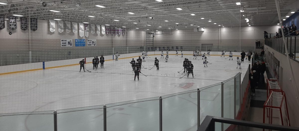 The Girls Hockey team warms-up for their match against the Worthington Trojans
